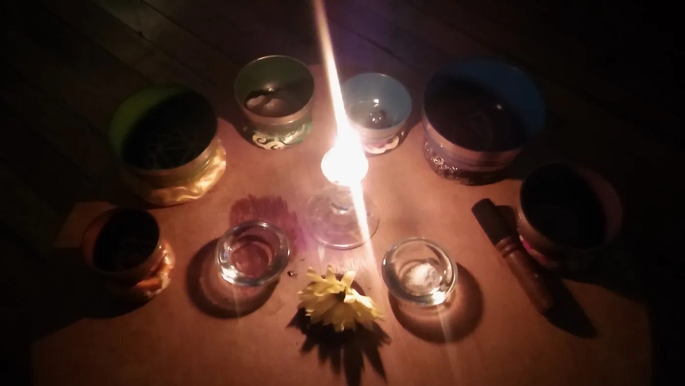 Candlelit spiritual altar with singing bowls