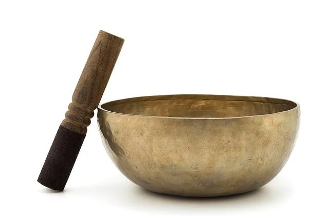 Brass singing bowl and wooden striker
