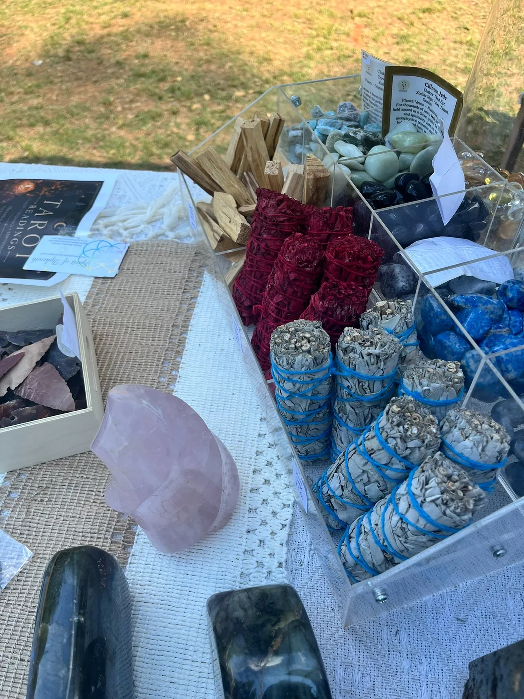 Bundles of sage, palo santo, crystals, and spiritual items on display